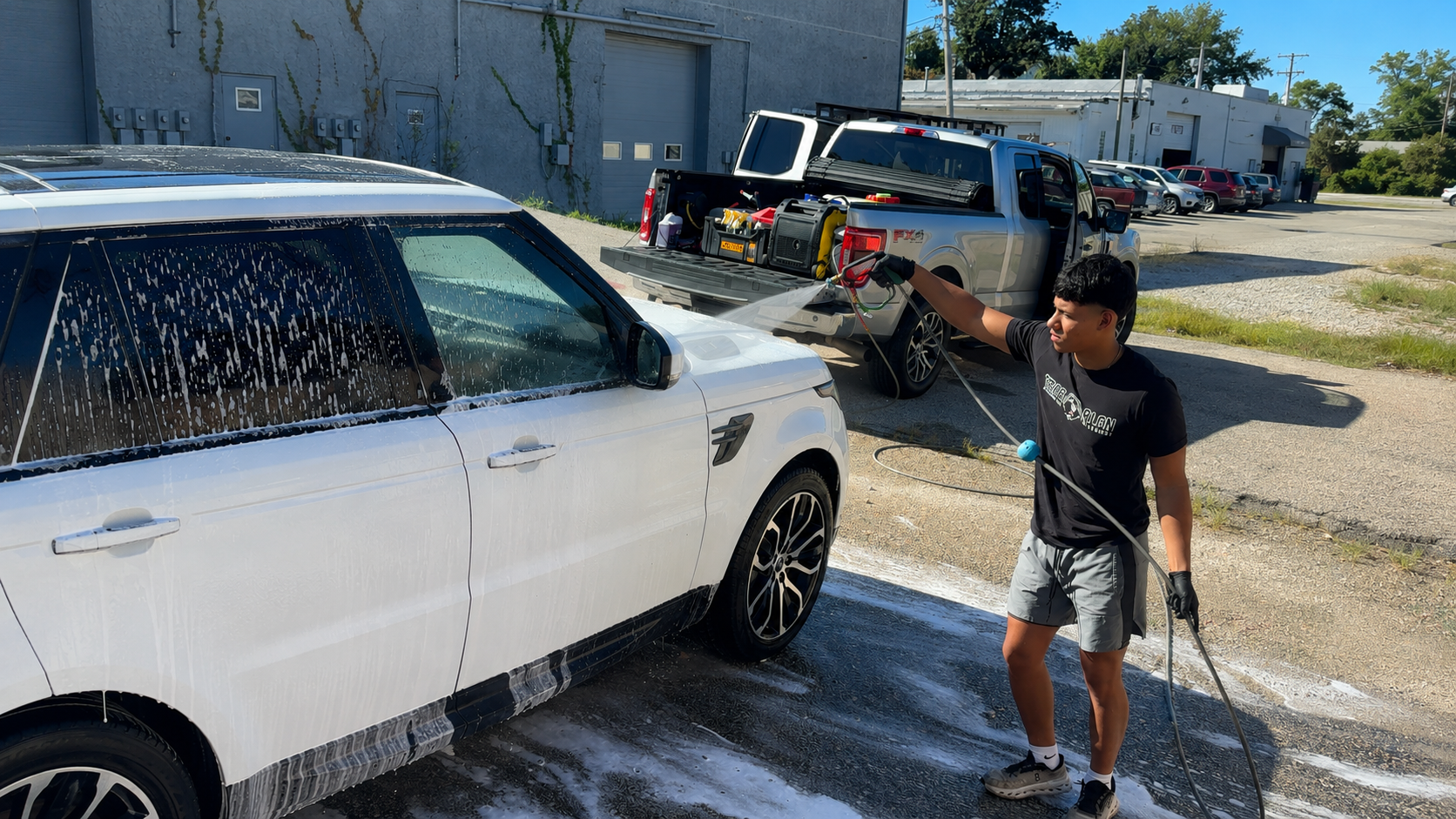 DetailCraft technician washing a customer vehicle